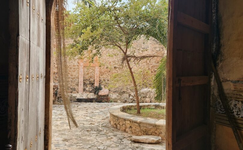 an open door leading to a courtyard with a hammock